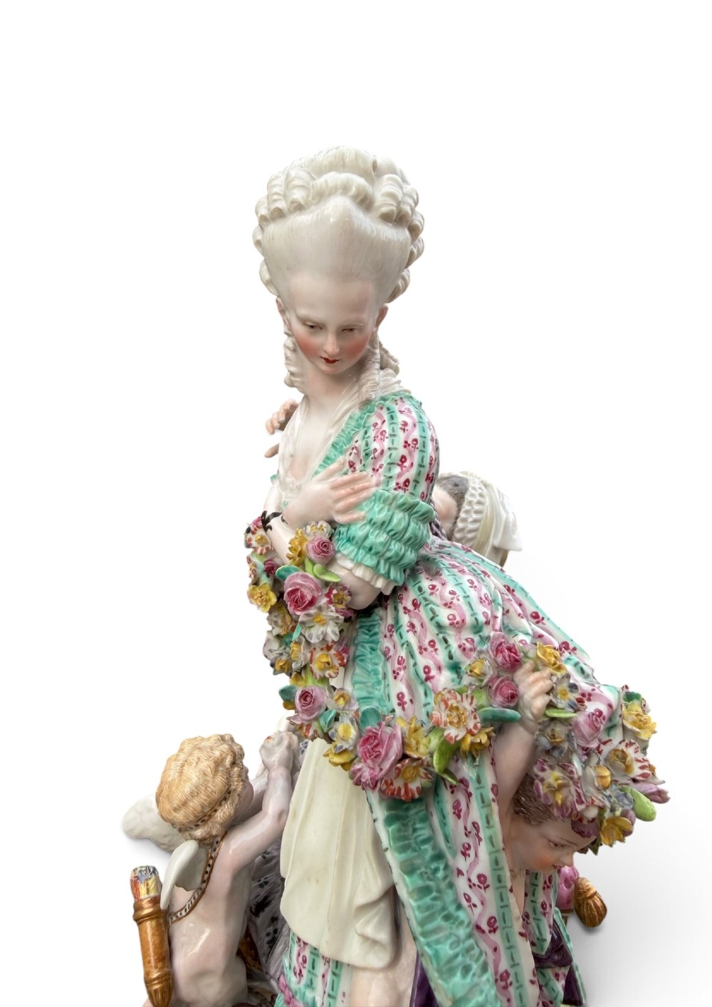 An eighteenth-century polychrome hard-paste porcelain figurine group depicting two classical figures and a cherub beside an overturned basket of eggs on a moulded fluted base. View XI