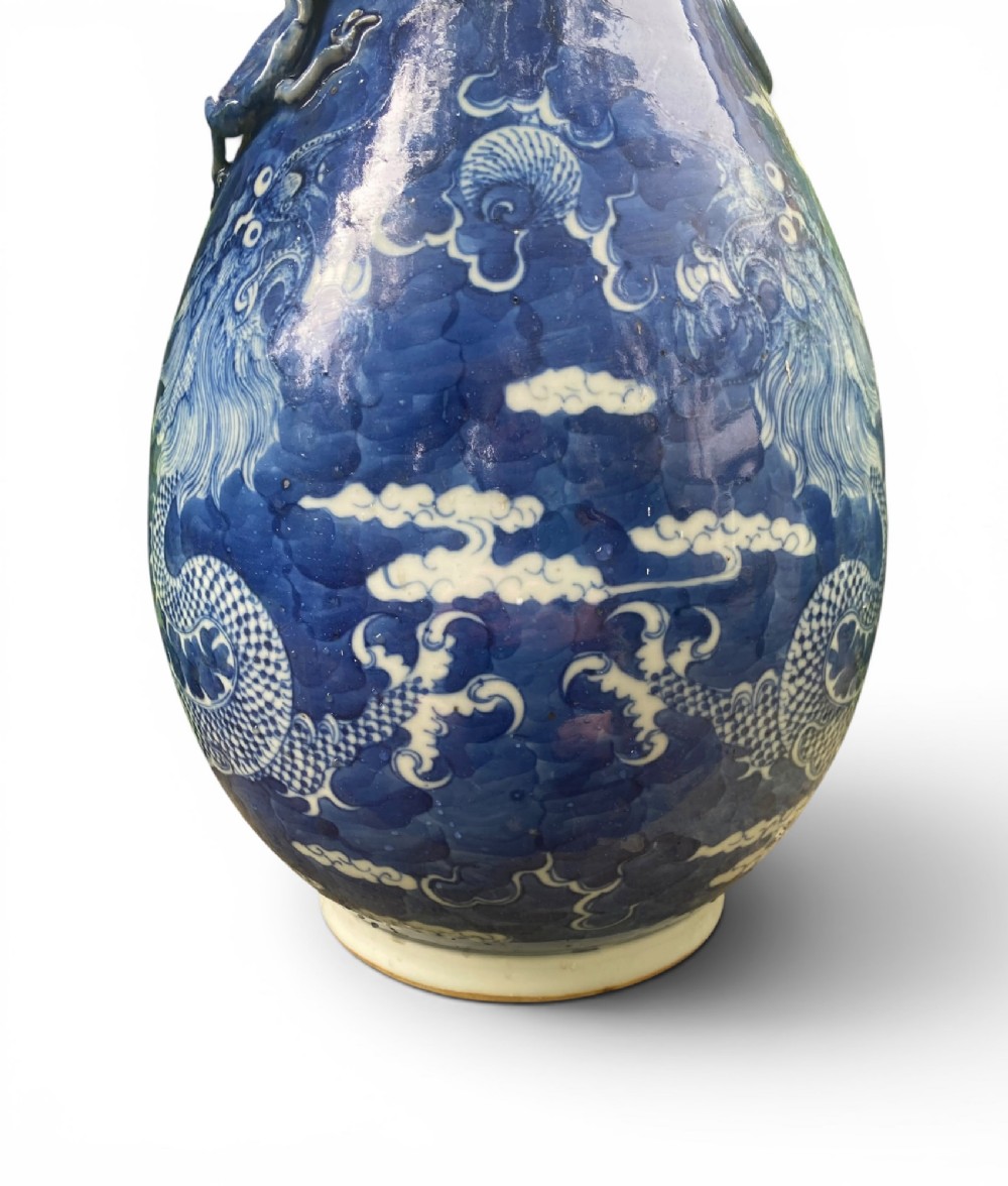 A 19th-century Qing Dynasty Chinese blue and white porcelain vase with hand-painted cloud motifs and an applied sculpted high-relief dragon around the neck. View II
