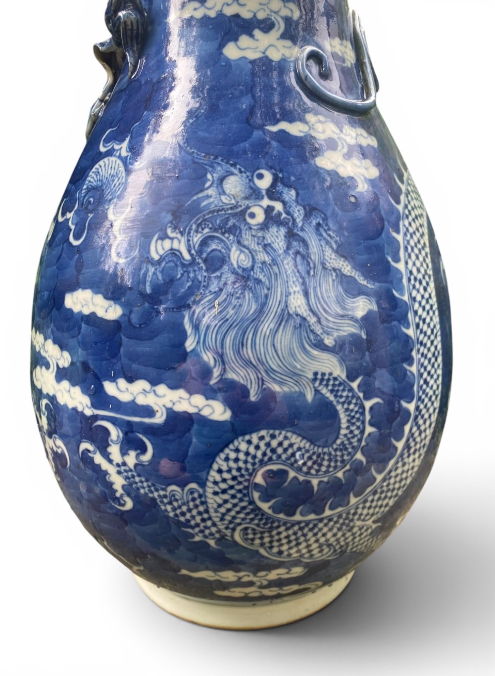A 19th-century Qing Dynasty Chinese blue and white porcelain vase with hand-painted cloud motifs and an applied sculpted high-relief dragon around the neck. View III