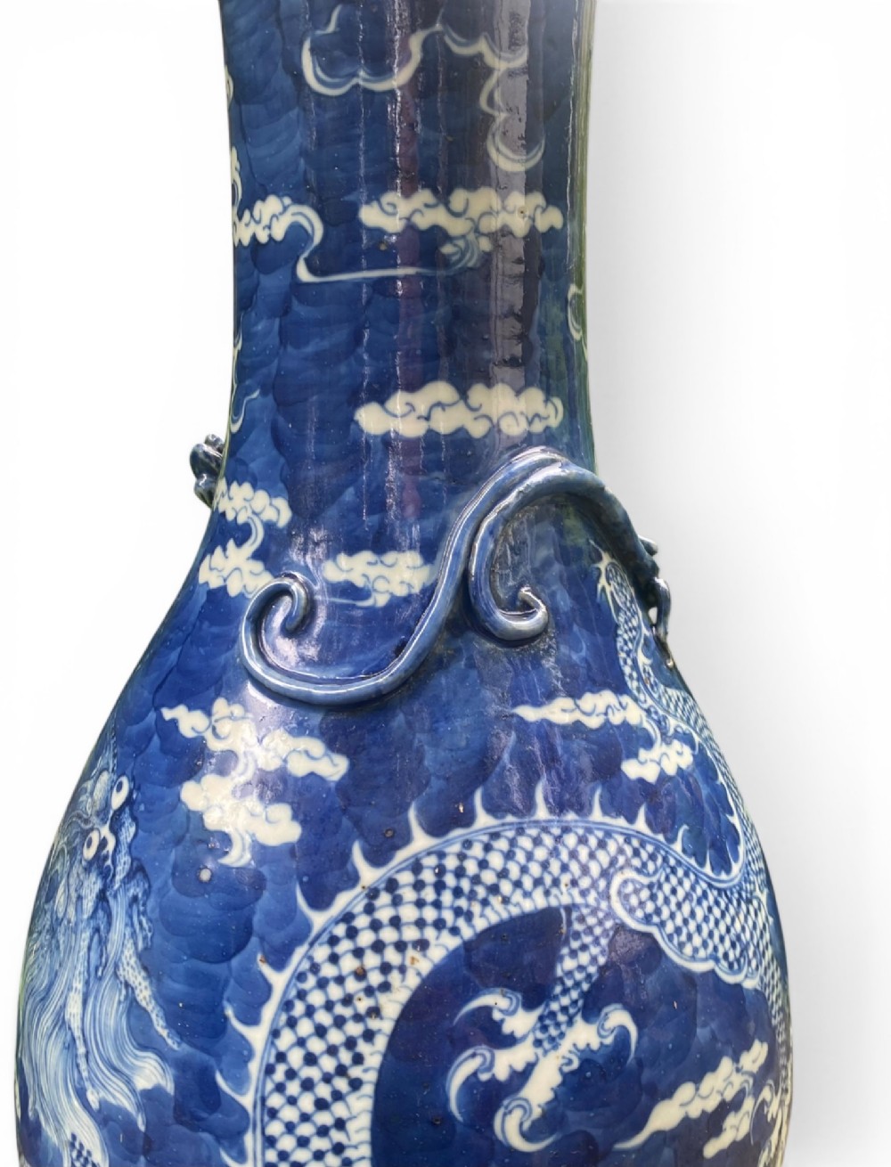 A 19th-century Qing Dynasty Chinese blue and white porcelain vase with hand-painted cloud motifs and an applied sculpted high-relief dragon around the neck. View V