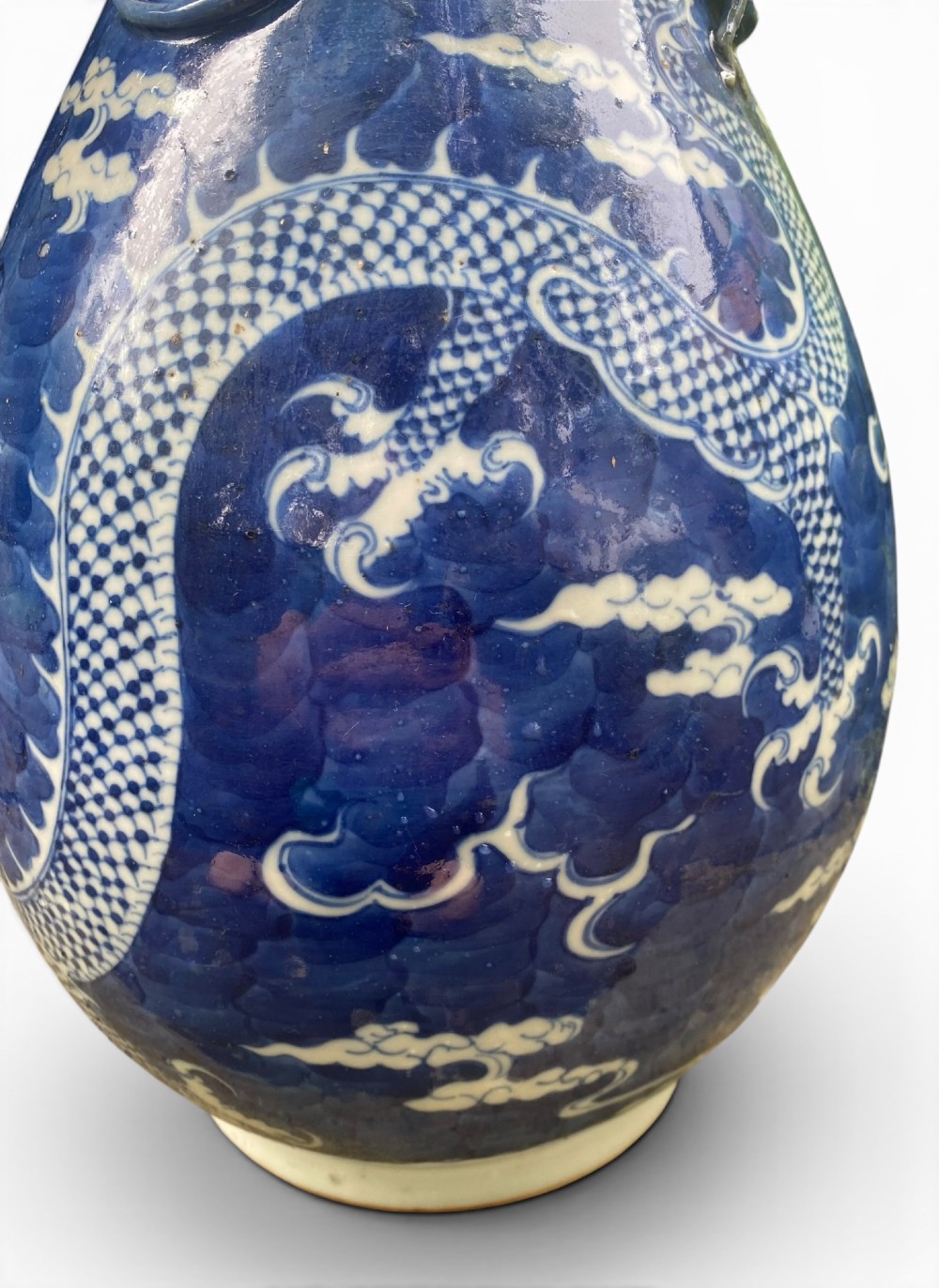 A 19th-century Qing Dynasty Chinese blue and white porcelain vase with hand-painted cloud motifs and an applied sculpted high-relief dragon around the neck. View VI