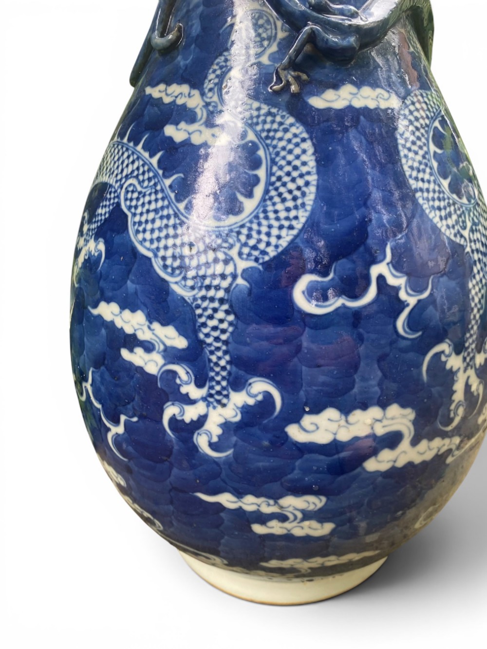 A 19th-century Qing Dynasty Chinese blue and white porcelain vase with hand-painted cloud motifs and an applied sculpted high-relief dragon around the neck. View VIII
