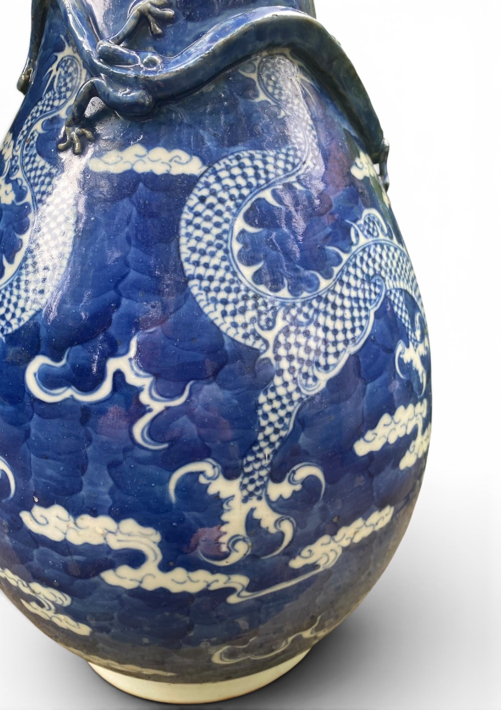A 19th-century Qing Dynasty Chinese blue and white porcelain vase with hand-painted cloud motifs and an applied sculpted high-relief dragon around the neck. View IX