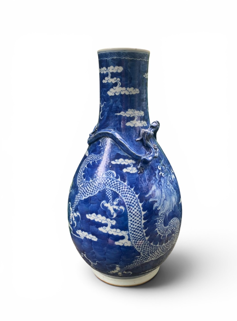 A 19th-century Qing Dynasty Chinese blue and white porcelain vase with hand-painted cloud motifs and an applied sculpted high-relief dragon around the neck. View XI