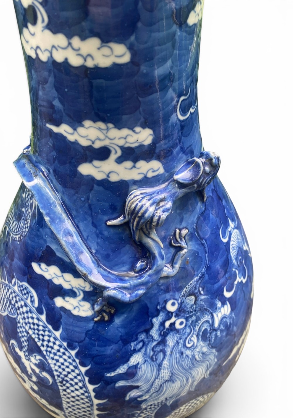 A 19th-century Qing Dynasty Chinese blue and white porcelain vase with hand-painted cloud motifs and an applied sculpted high-relief dragon around the neck. View XII
