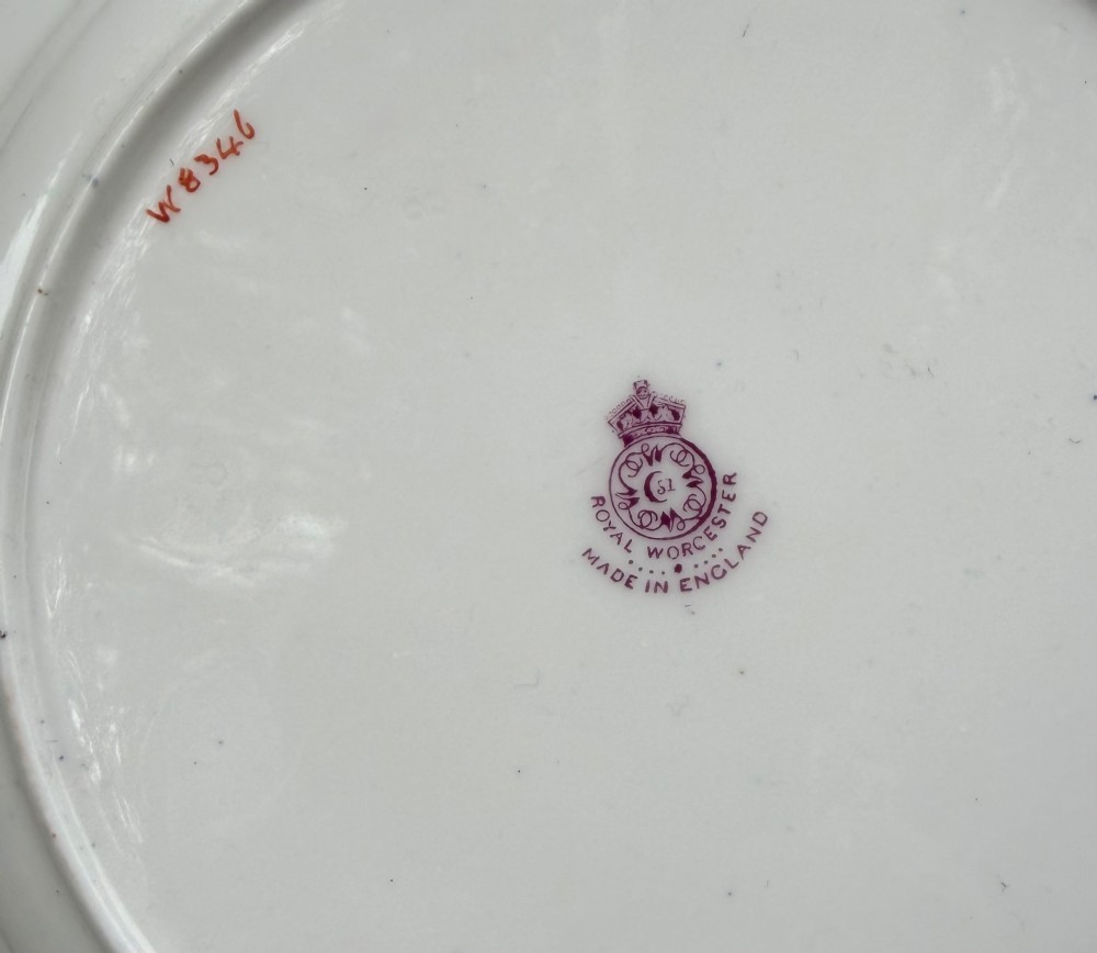 A circular Royal Worcester porcelain cabinet plate featuring a central hand-painted fruit study surrounded by an ornate cobalt blue and gilded rim. View VI