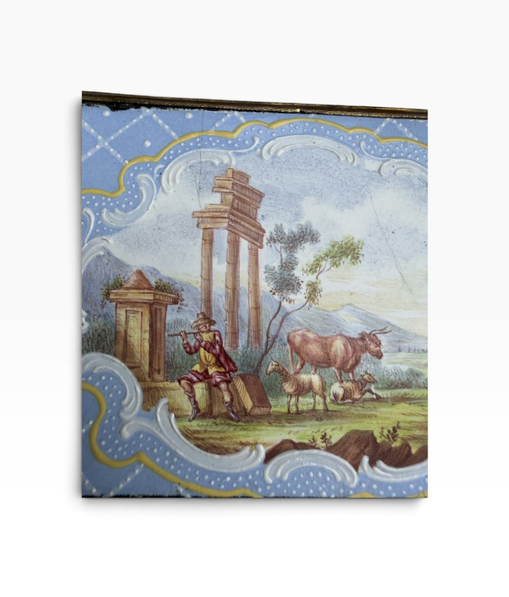 A rectangular Georgian enamel snuff box featuring a light blue trellis background, gilt metal mounts, and hand-painted pastoral scenes in central cartouches. View XI