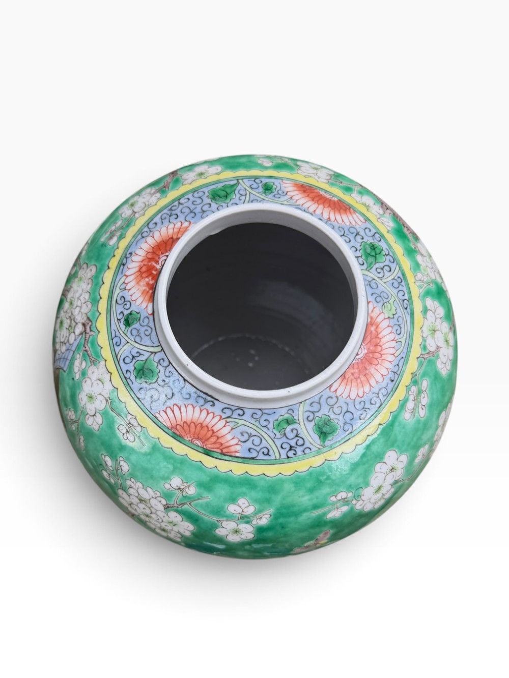A 19th-century Chinese porcelain ginger jar with a matching domed cover, decorated with hand-painted birds and white blossoms on a green background. View VII
