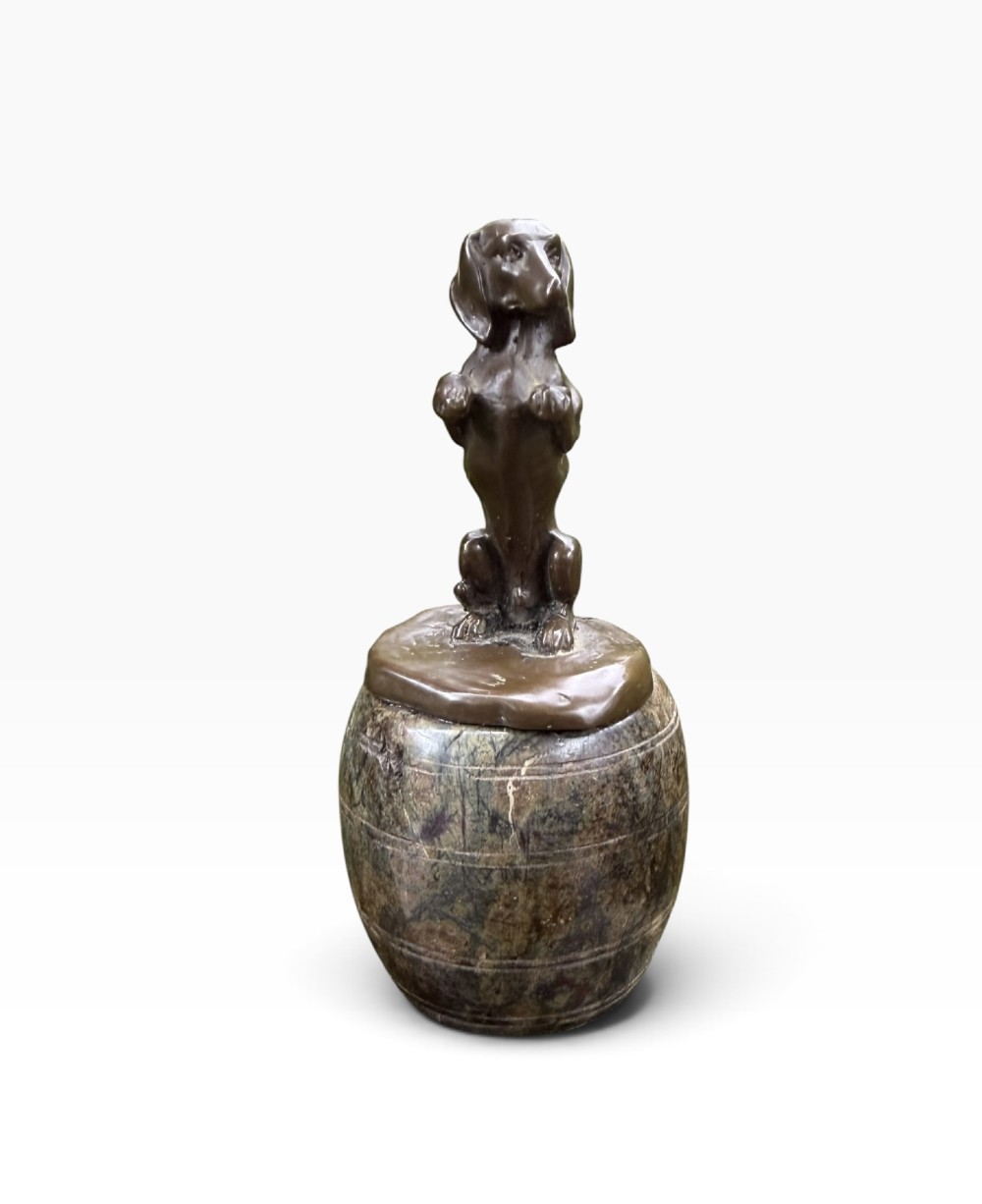 A small dark bronze sculpture of a dachshund standing on its hind legs in a begging position, mounted atop a carved marble barrel base. View II