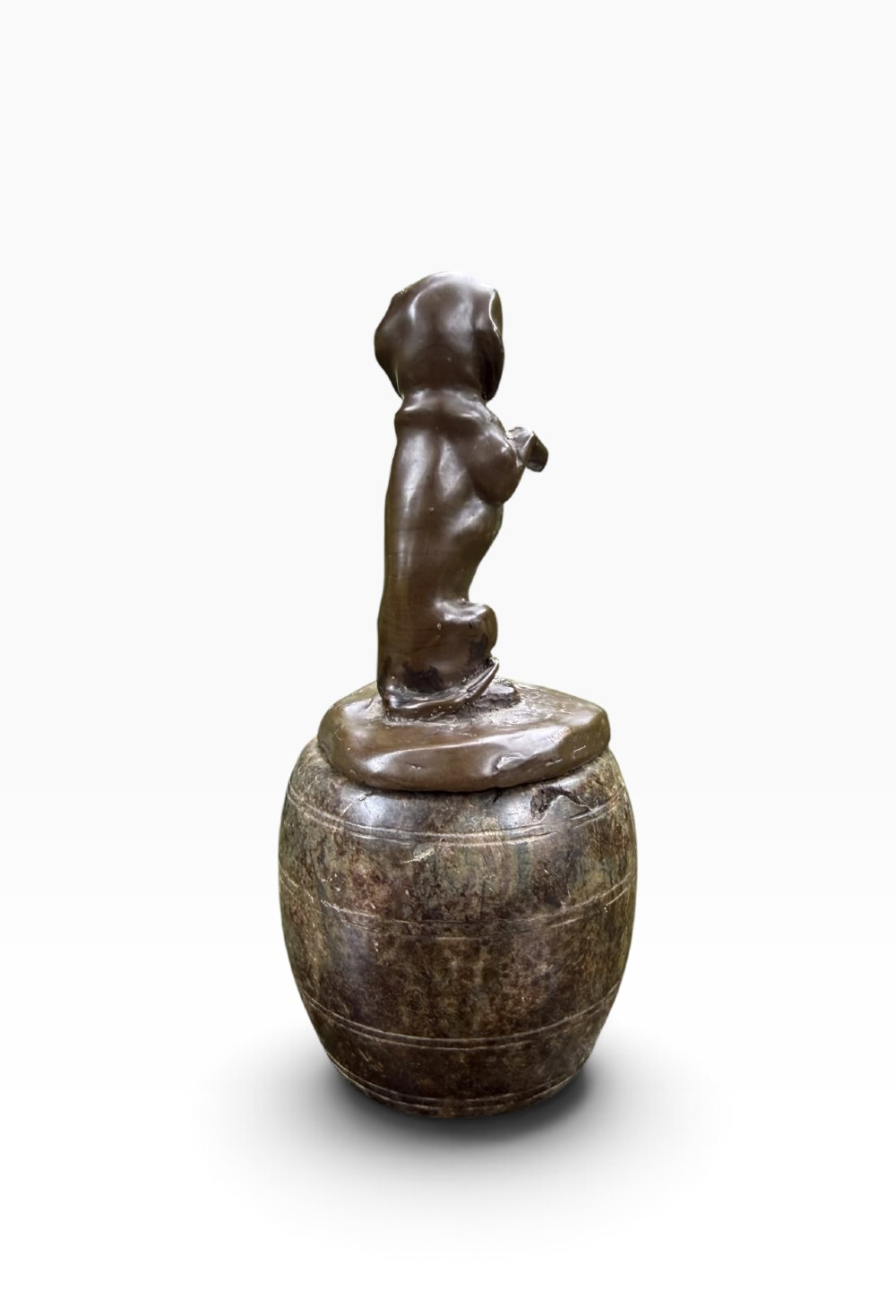 A small dark bronze sculpture of a dachshund standing on its hind legs in a begging position, mounted atop a carved marble barrel base. View IV