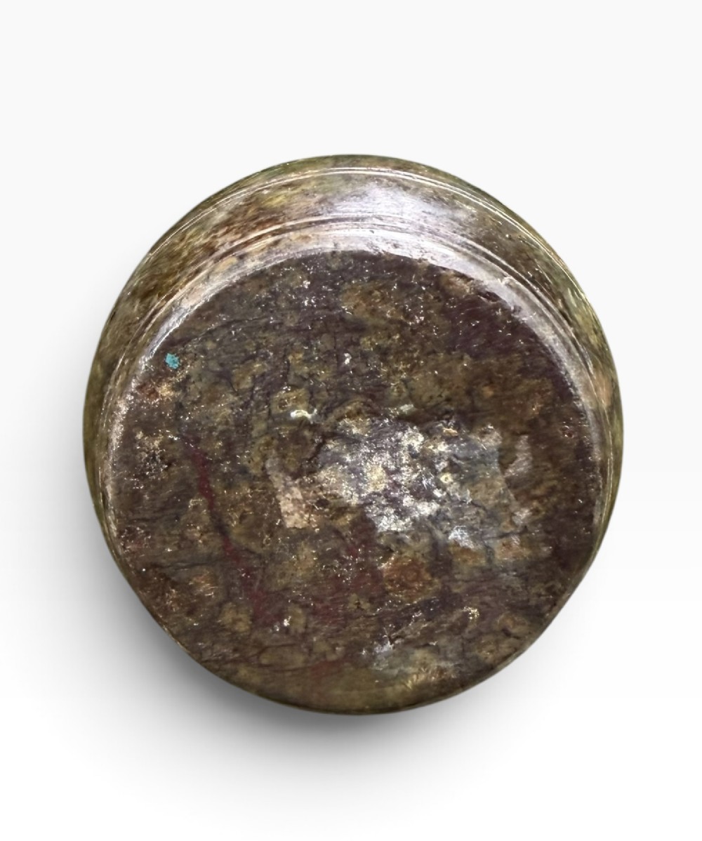 A small dark bronze sculpture of a dachshund standing on its hind legs in a begging position, mounted atop a carved marble barrel base. View VII