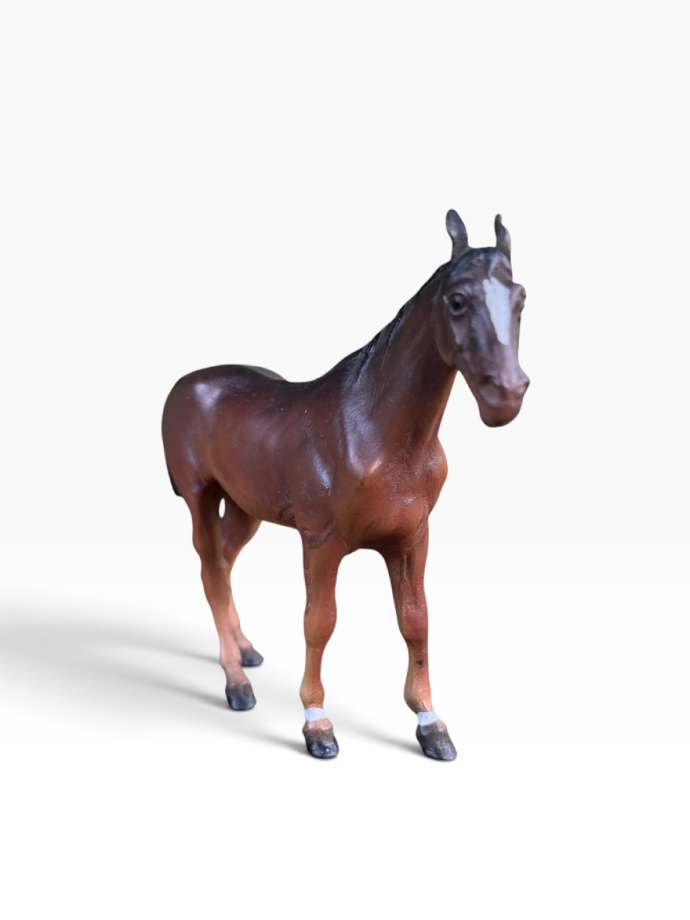 An antique Austrian cold-painted bronze figurine depicting a standing brown horse with a black mane and tail. View V