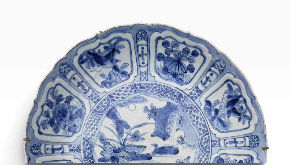 An antique Chinese Kraak porcelain dish featuring underglaze cobalt blue decoration, a central roundel with waterfowl, and a lobed border with radiating panels. View III