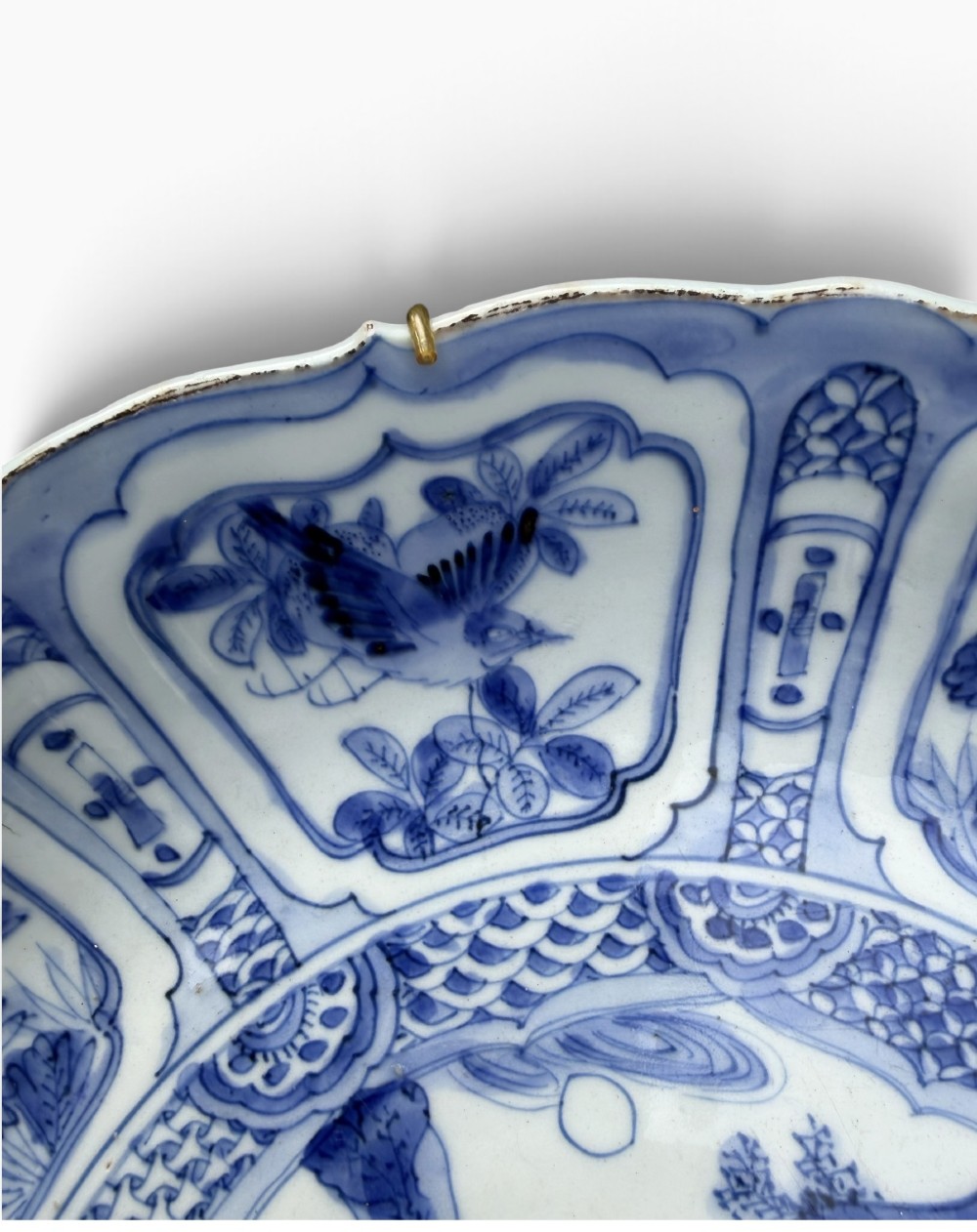 An antique Chinese Kraak porcelain dish featuring underglaze cobalt blue decoration, a central roundel with waterfowl, and a lobed border with radiating panels. View IV