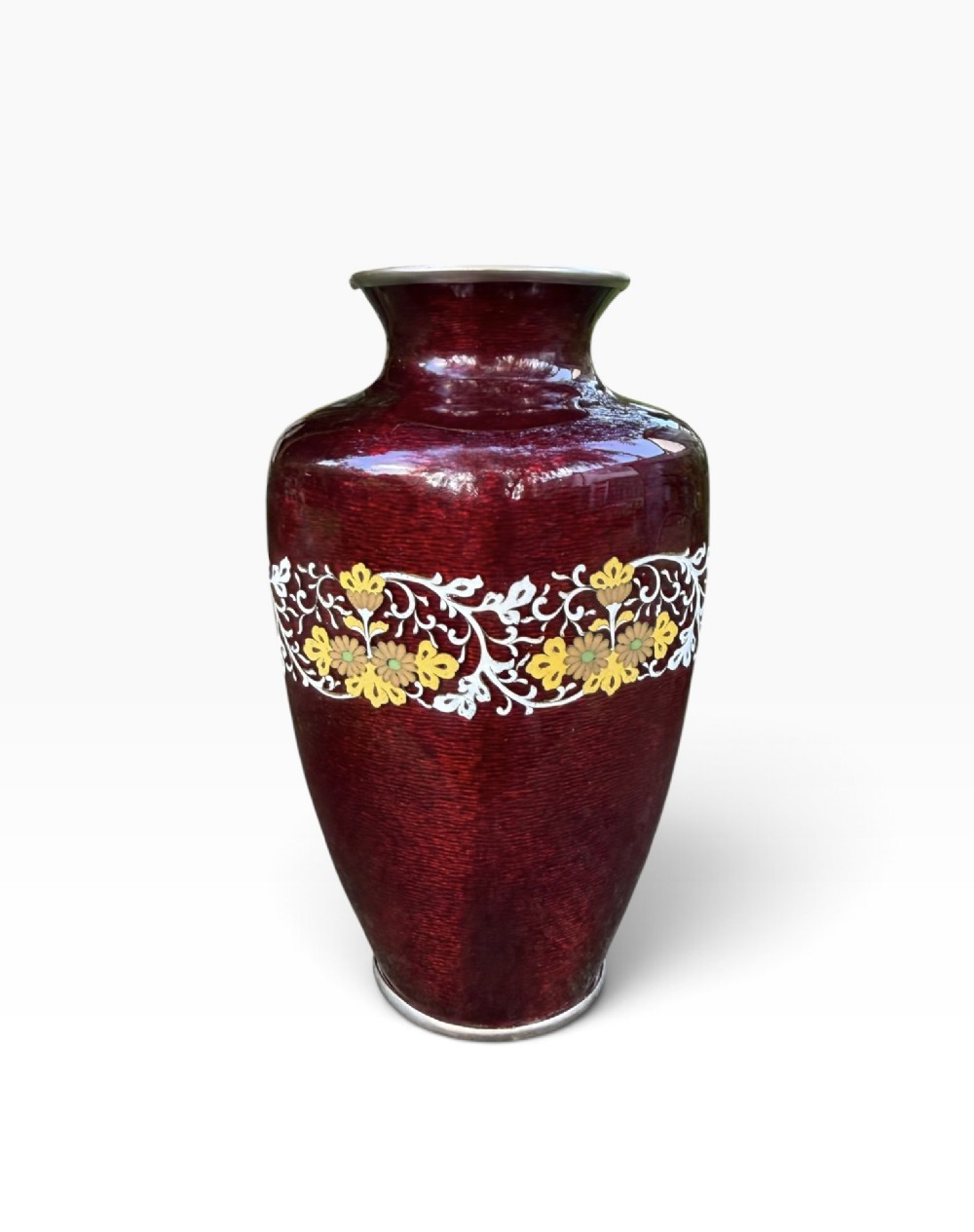 A baluster-shaped Japanese ginbari cloisonne vase featuring deep crimson enamel over foil, decorated with a band of yellow blossoms and white scrolling foliage around the center. View III