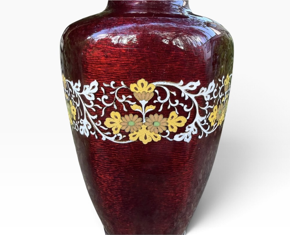 A baluster-shaped Japanese ginbari cloisonne vase featuring deep crimson enamel over foil, decorated with a band of yellow blossoms and white scrolling foliage around the center. View IV