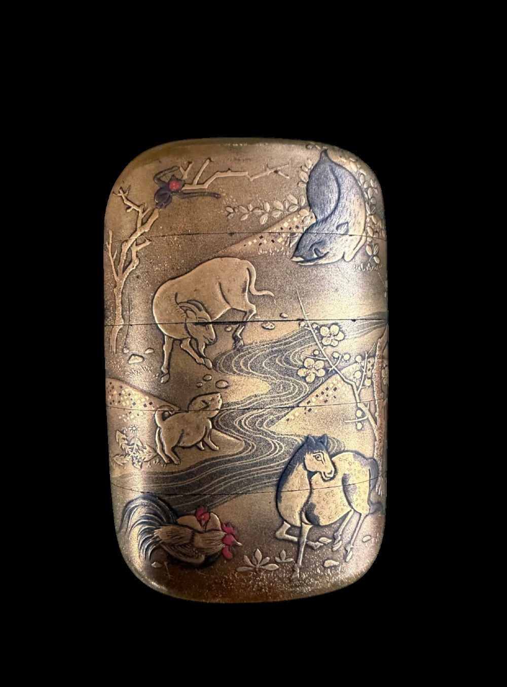 A multi-tiered Japanese gold maki-e lacquer inro featuring detailed relief depictions of zodiac animals including an ox, rabbit, rat, snake, and tiger. View II