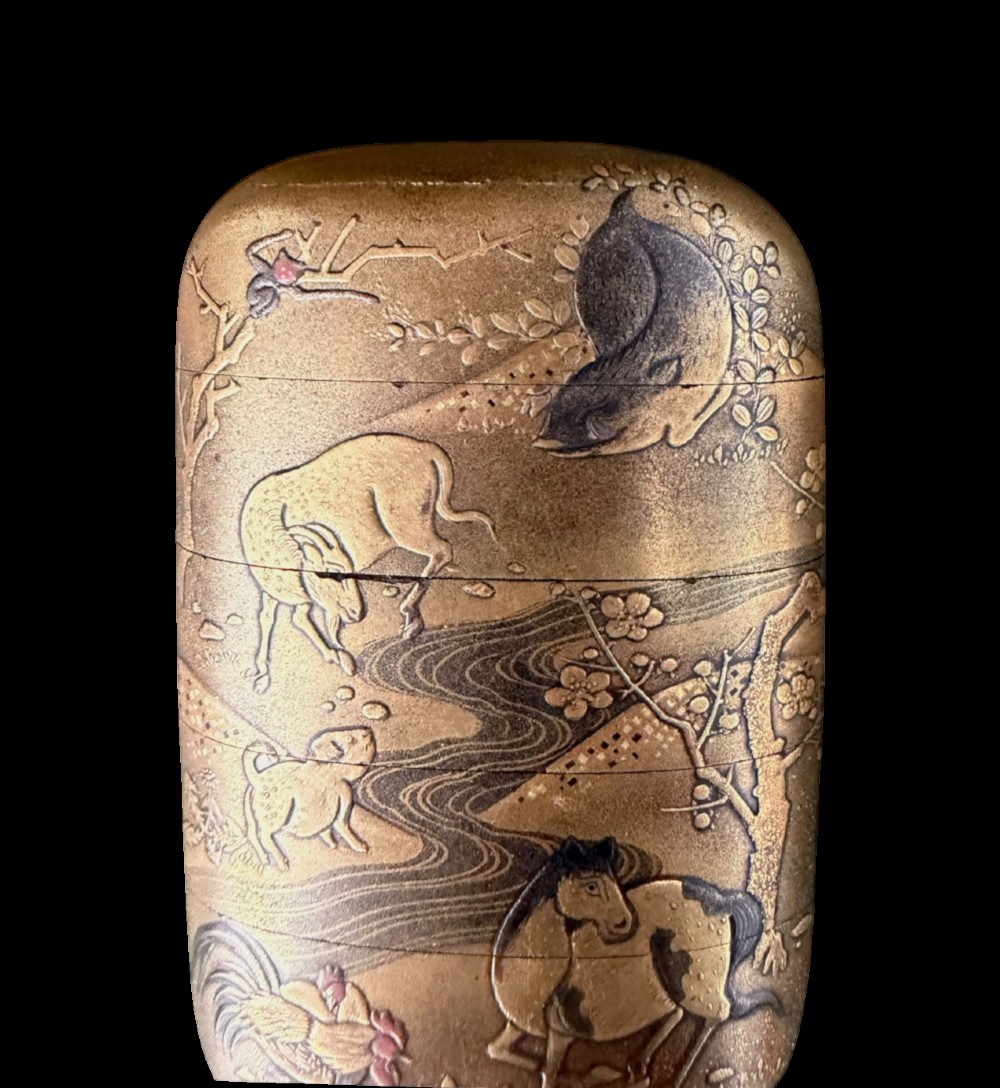 A multi-tiered Japanese gold maki-e lacquer inro featuring detailed relief depictions of zodiac animals including an ox, rabbit, rat, snake, and tiger. View VI