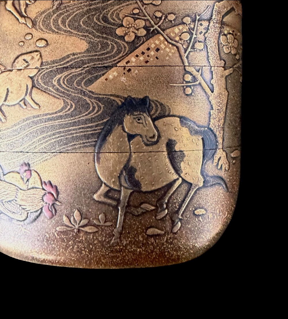 A multi-tiered Japanese gold maki-e lacquer inro featuring detailed relief depictions of zodiac animals including an ox, rabbit, rat, snake, and tiger. View VII