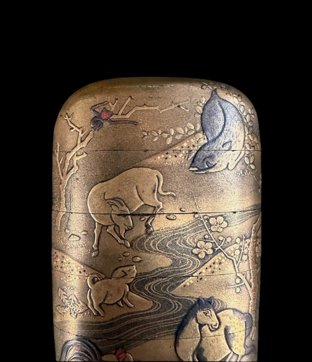A multi-tiered Japanese gold maki-e lacquer inro featuring detailed relief depictions of zodiac animals including an ox, rabbit, rat, snake, and tiger. View VIII