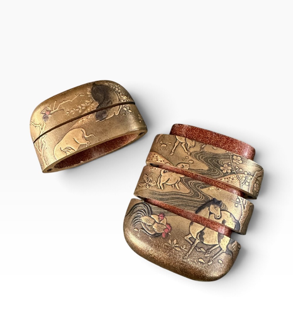 A multi-tiered Japanese gold maki-e lacquer inro featuring detailed relief depictions of zodiac animals including an ox, rabbit, rat, snake, and tiger. View XII