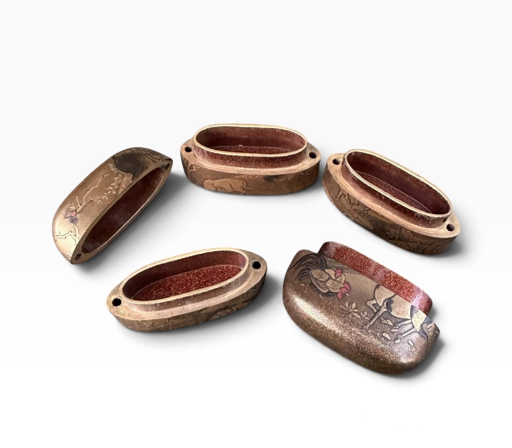 A multi-tiered Japanese gold maki-e lacquer inro featuring detailed relief depictions of zodiac animals including an ox, rabbit, rat, snake, and tiger. View XIII