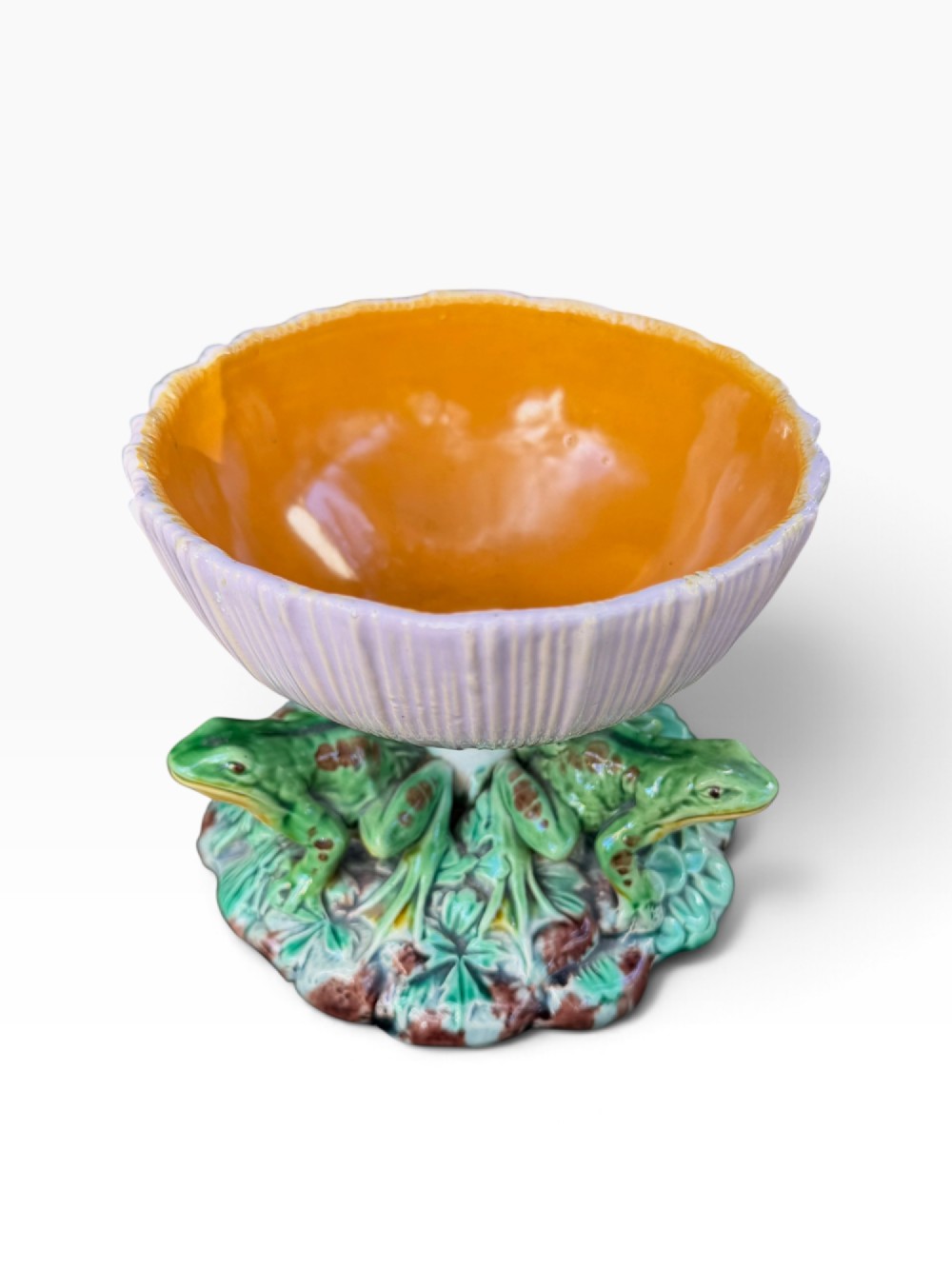 A Victorian Minton majolica footed bowl featuring three-dimensional green frogs on a leafy base supporting a fluted lilac flower-form bowl with a yellow glazed interior. View II