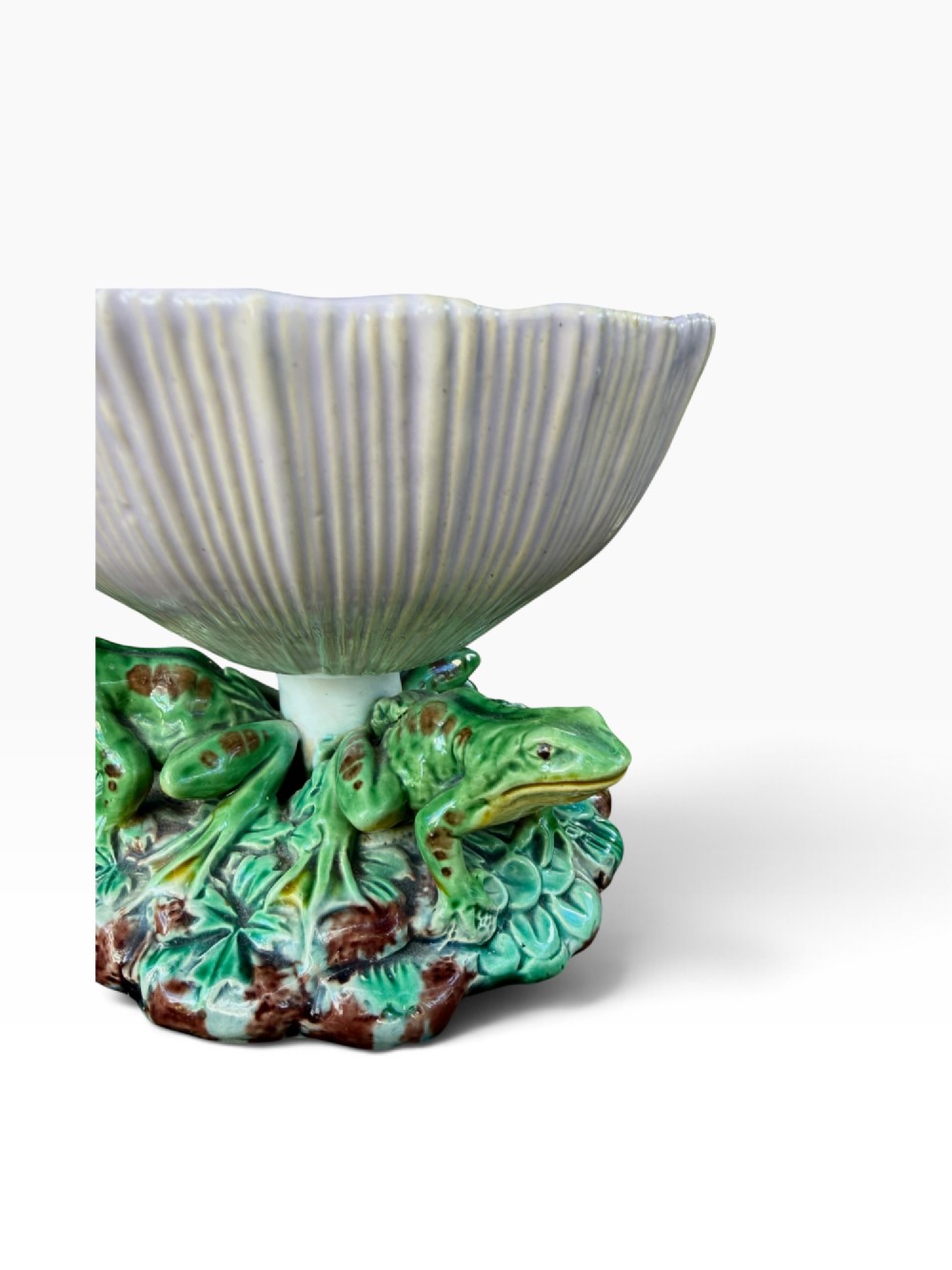 A Victorian Minton majolica footed bowl featuring three-dimensional green frogs on a leafy base supporting a fluted lilac flower-form bowl with a yellow glazed interior. View IV
