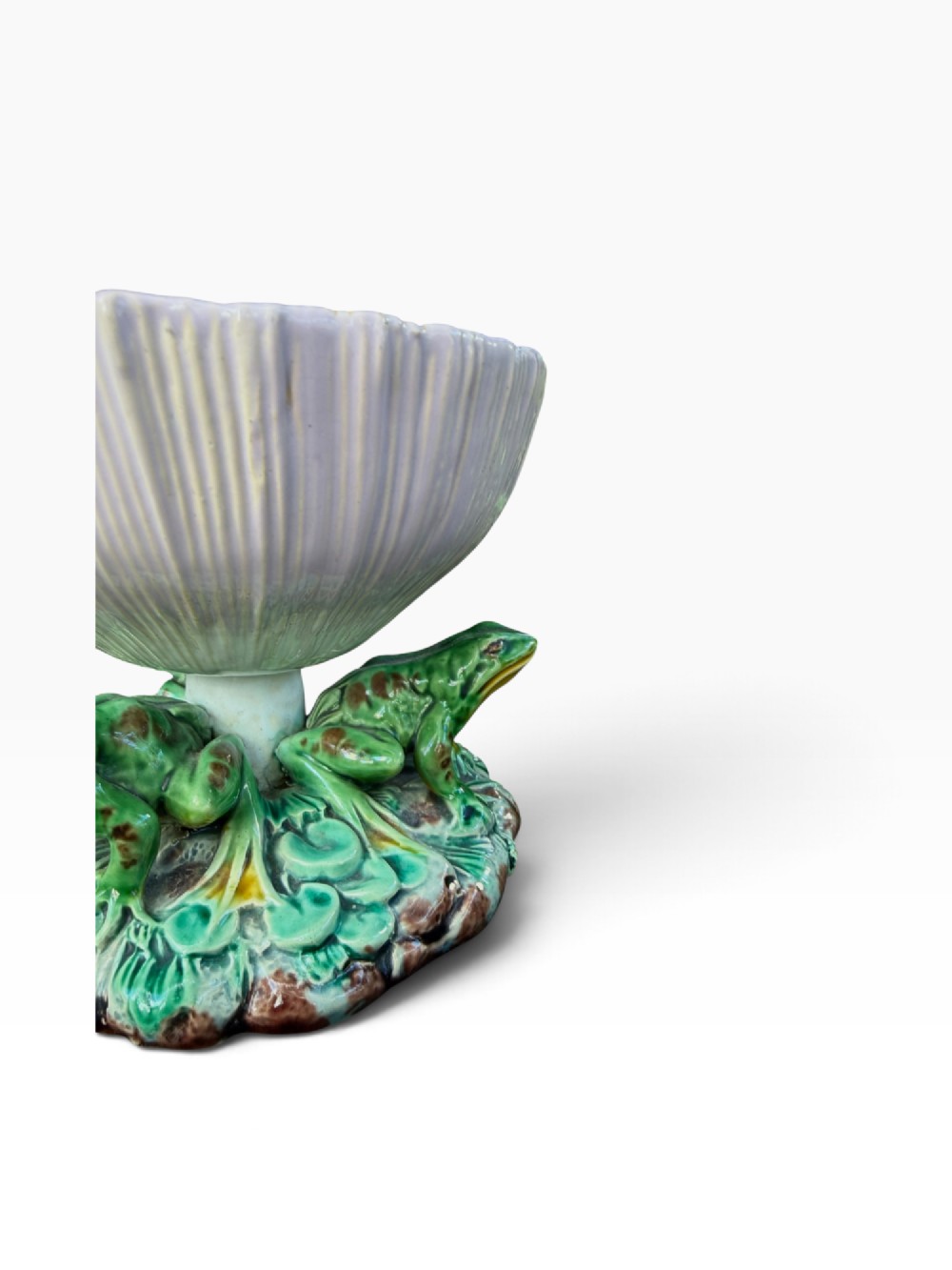 A Victorian Minton majolica footed bowl featuring three-dimensional green frogs on a leafy base supporting a fluted lilac flower-form bowl with a yellow glazed interior. View V