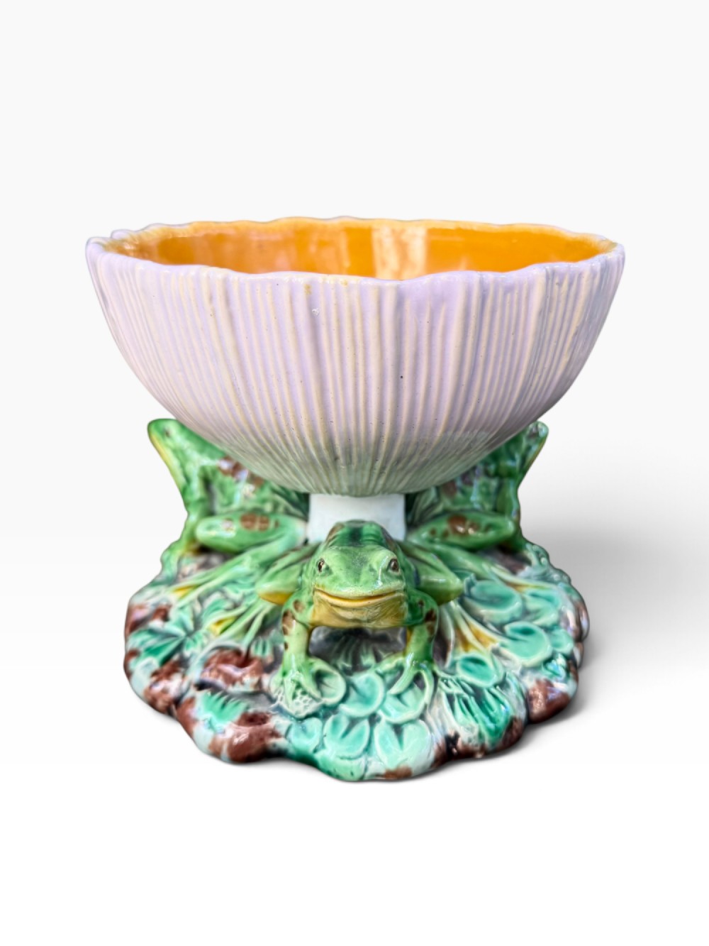 A Victorian Minton majolica footed bowl featuring three-dimensional green frogs on a leafy base supporting a fluted lilac flower-form bowl with a yellow glazed interior. View VI