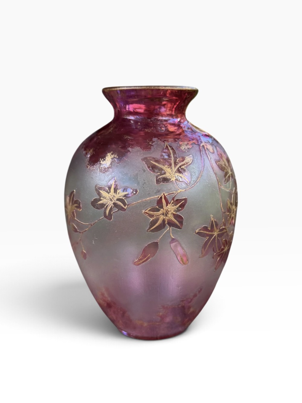 An Art Nouveau glass vase displaying a frosted gradient body from deep crimson red to soft pink, decorated with acid-etched gilt foliage.