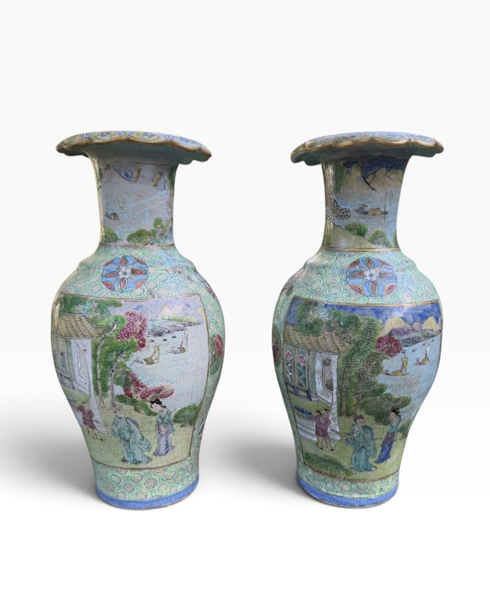 A pair of 19th-century Chinese Yixing stoneware baluster vases decorated in vibrant polychrome enamels with figural panels on a patterned green ground. View II