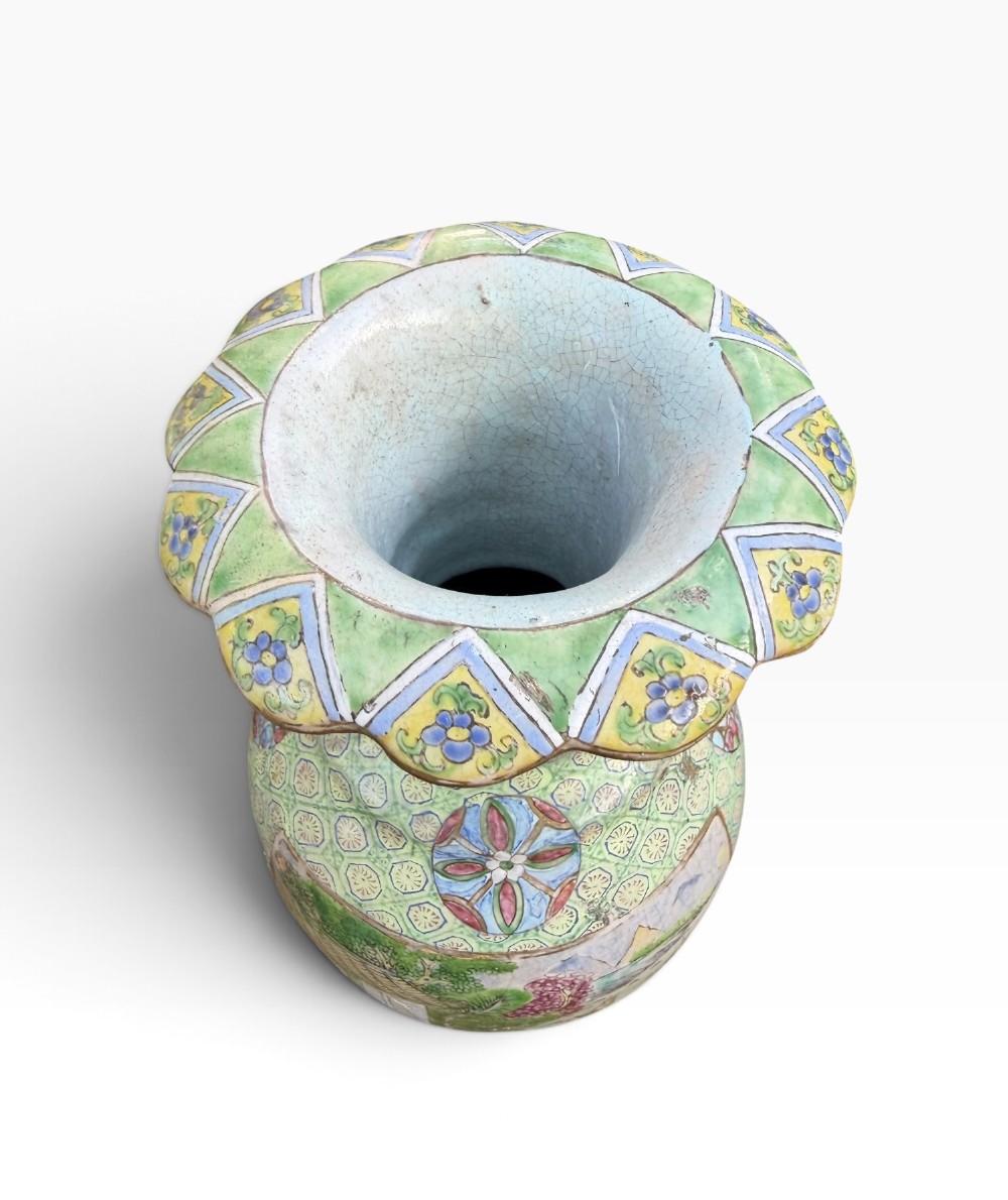 A pair of 19th-century Chinese Yixing stoneware baluster vases decorated in vibrant polychrome enamels with figural panels on a patterned green ground. View VI