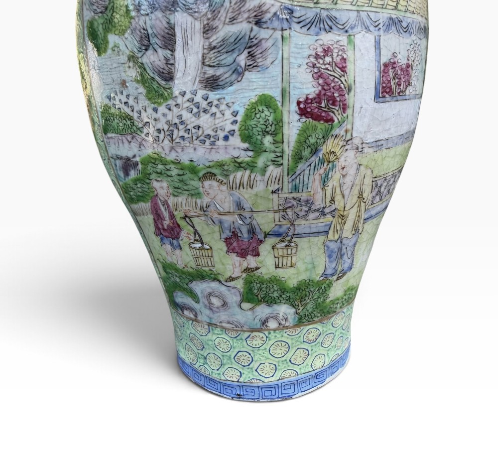 A pair of 19th-century Chinese Yixing stoneware baluster vases decorated in vibrant polychrome enamels with figural panels on a patterned green ground. View VIII
