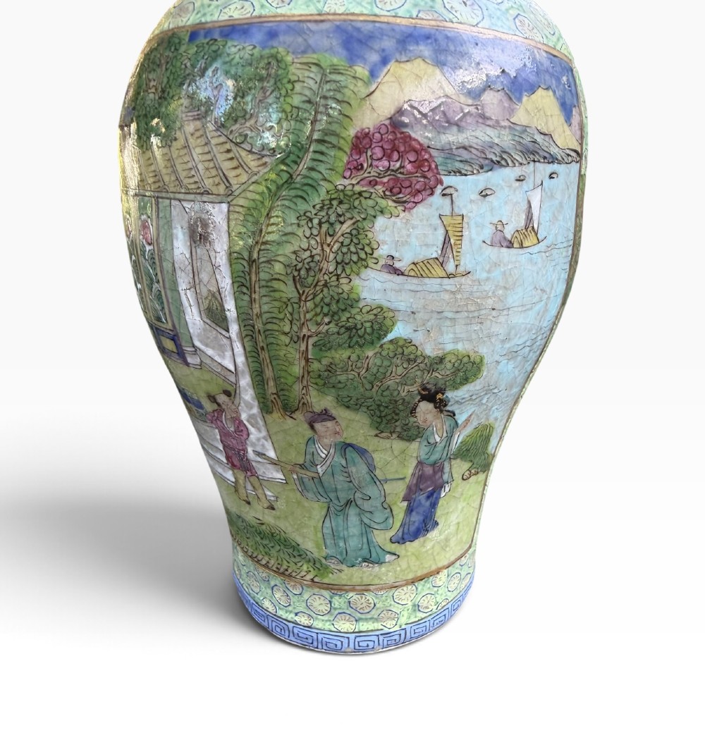 A pair of 19th-century Chinese Yixing stoneware baluster vases decorated in vibrant polychrome enamels with figural panels on a patterned green ground. View XII