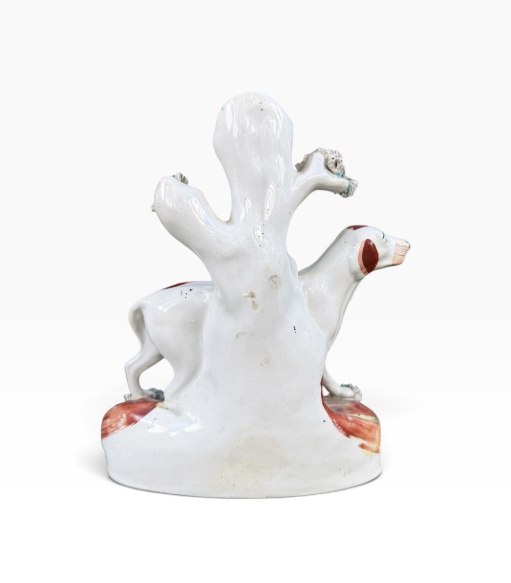 A Victorian Staffordshire pottery spill vase featuring a white and brown pointer dog standing in front of a tree trunk on a moulded base. View III