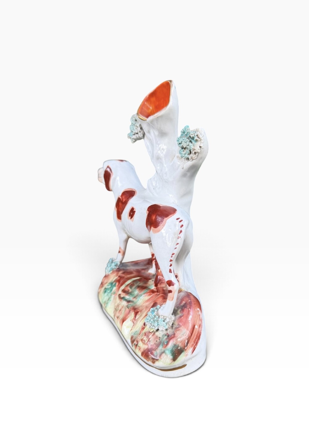 A Victorian Staffordshire pottery spill vase featuring a white and brown pointer dog standing in front of a tree trunk on a moulded base. View IV