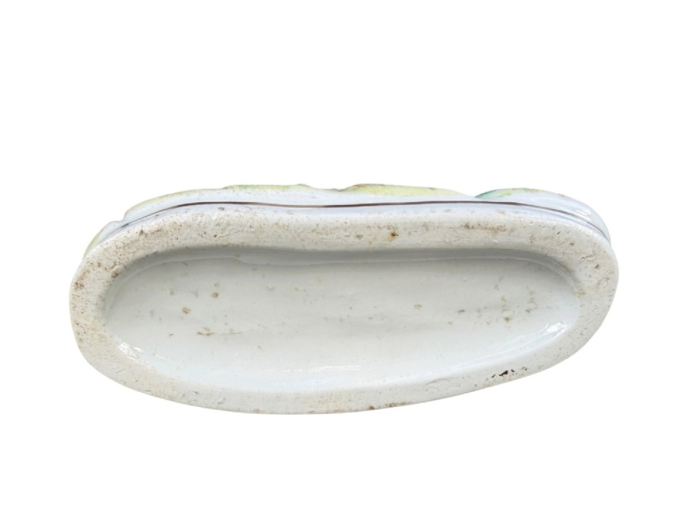 A Victorian Staffordshire pottery spill vase featuring a white and brown pointer dog standing in front of a tree trunk on a moulded base. View VII