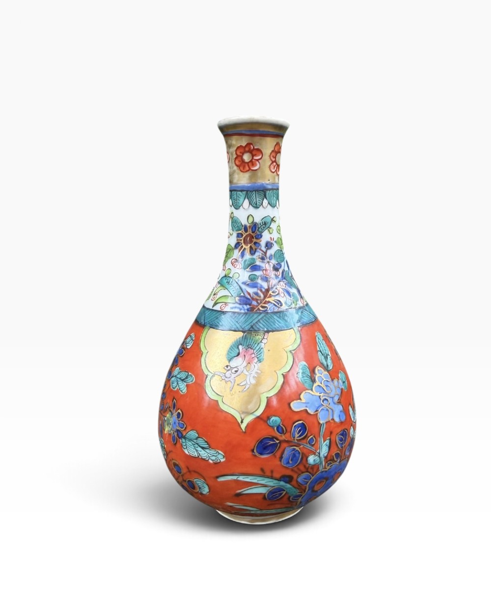 An antique pear-shaped Chinese clobbered porcelain vase featuring floral patterns in red, blue, green, and gold enamel. View II