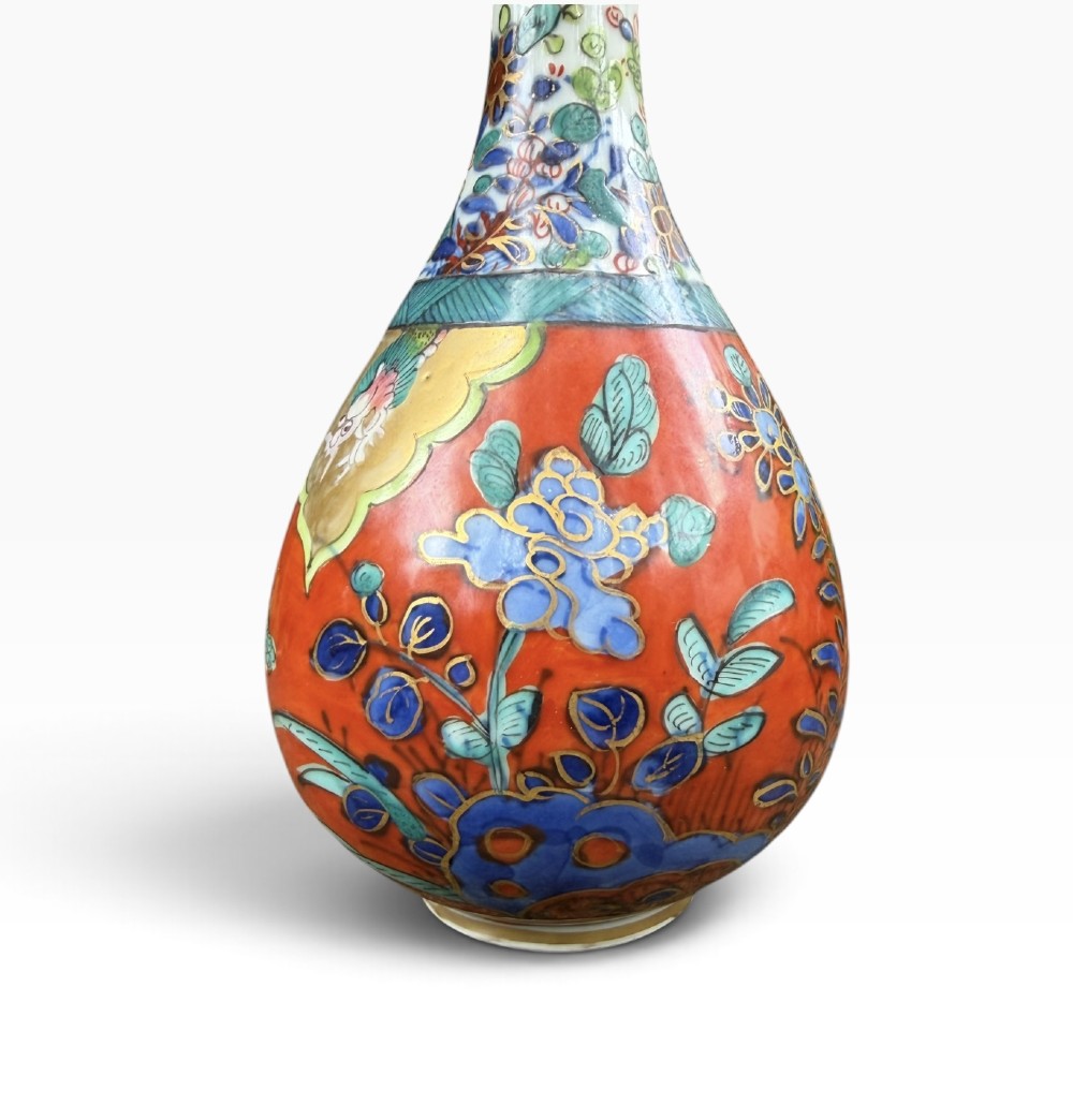 An antique pear-shaped Chinese clobbered porcelain vase featuring floral patterns in red, blue, green, and gold enamel. View V