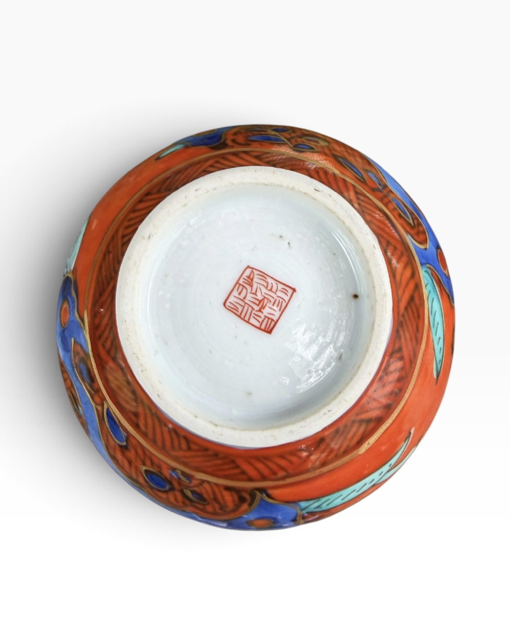 An antique pear-shaped Chinese clobbered porcelain vase featuring floral patterns in red, blue, green, and gold enamel. View VI