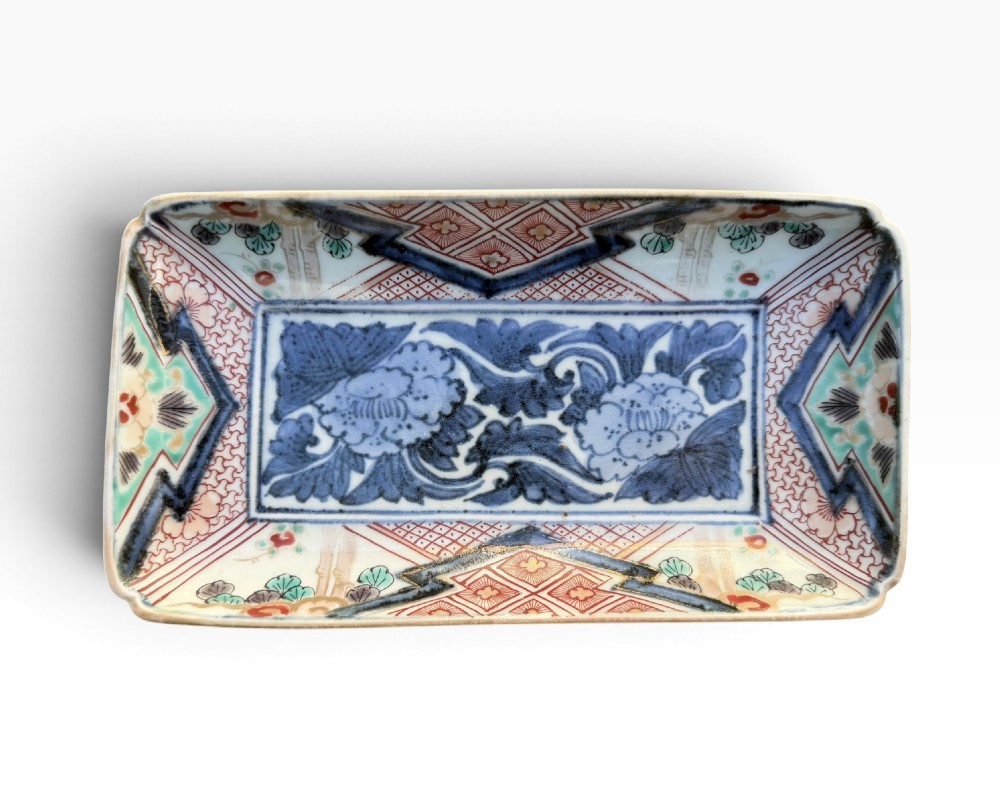 A pair of rectangular Japanese Imari porcelain dishes decorated with central blue floral panels and geometric diaper borders. View II