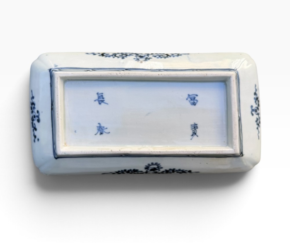 A pair of rectangular Japanese Imari porcelain dishes decorated with central blue floral panels and geometric diaper borders. View V