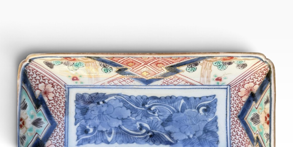 A pair of rectangular Japanese Imari porcelain dishes decorated with central blue floral panels and geometric diaper borders. View VI