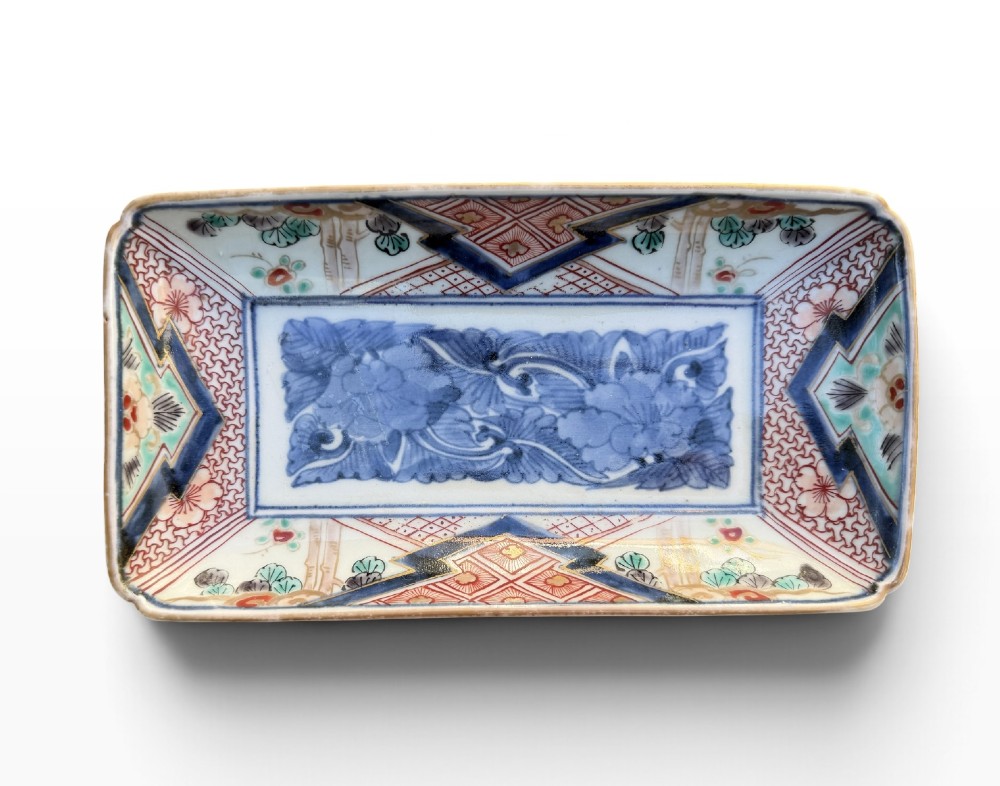 A pair of rectangular Japanese Imari porcelain dishes decorated with central blue floral panels and geometric diaper borders. View VII