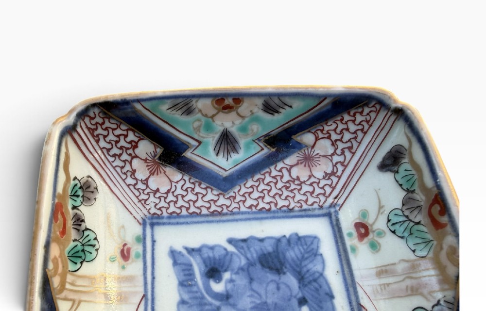 A pair of rectangular Japanese Imari porcelain dishes decorated with central blue floral panels and geometric diaper borders. View IX