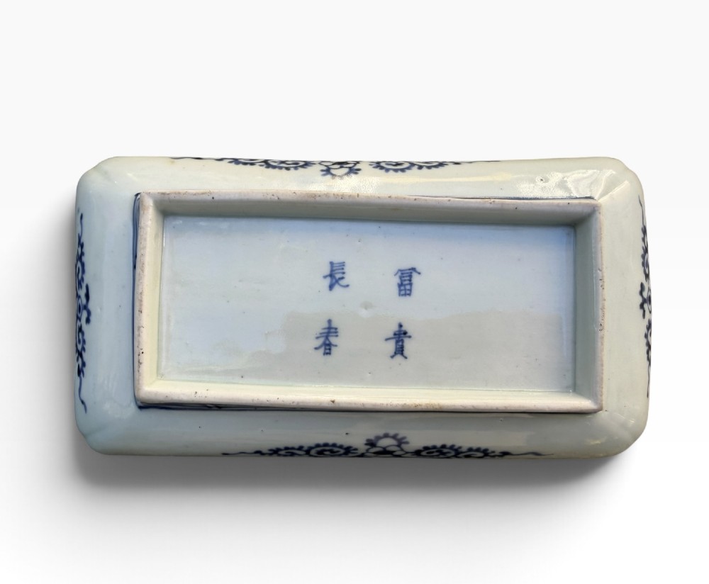 A pair of rectangular Japanese Imari porcelain dishes decorated with central blue floral panels and geometric diaper borders. View XI