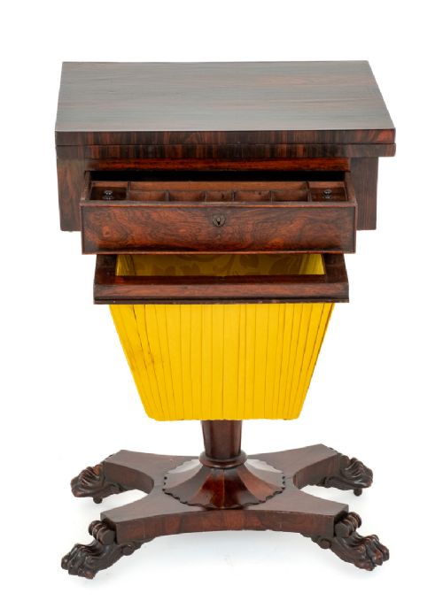 fig 1. A Regency rosewood games table featuring an inlaid chessboard and backgammon top over a yellow pleated fabric work basket, raised on a pedestal with carved paw feet.