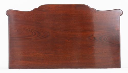 fig 2. A Georgian Revival mahogany chest of drawers featuring four shaped drawers with circular brass ring handles and bracket feet.