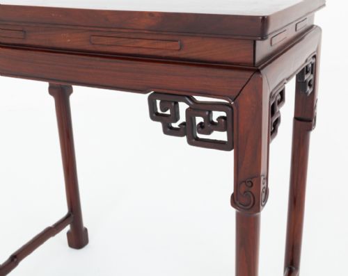 fig 1. A rectangular Chinese style hardwood occasional table featuring carved corner spandrels, straight legs with low stretchers, and a framed top.